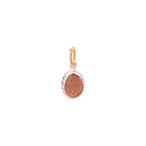 a small oval glitter sunstone pendant woven with light pink thread charm for woman, gold plated hanger